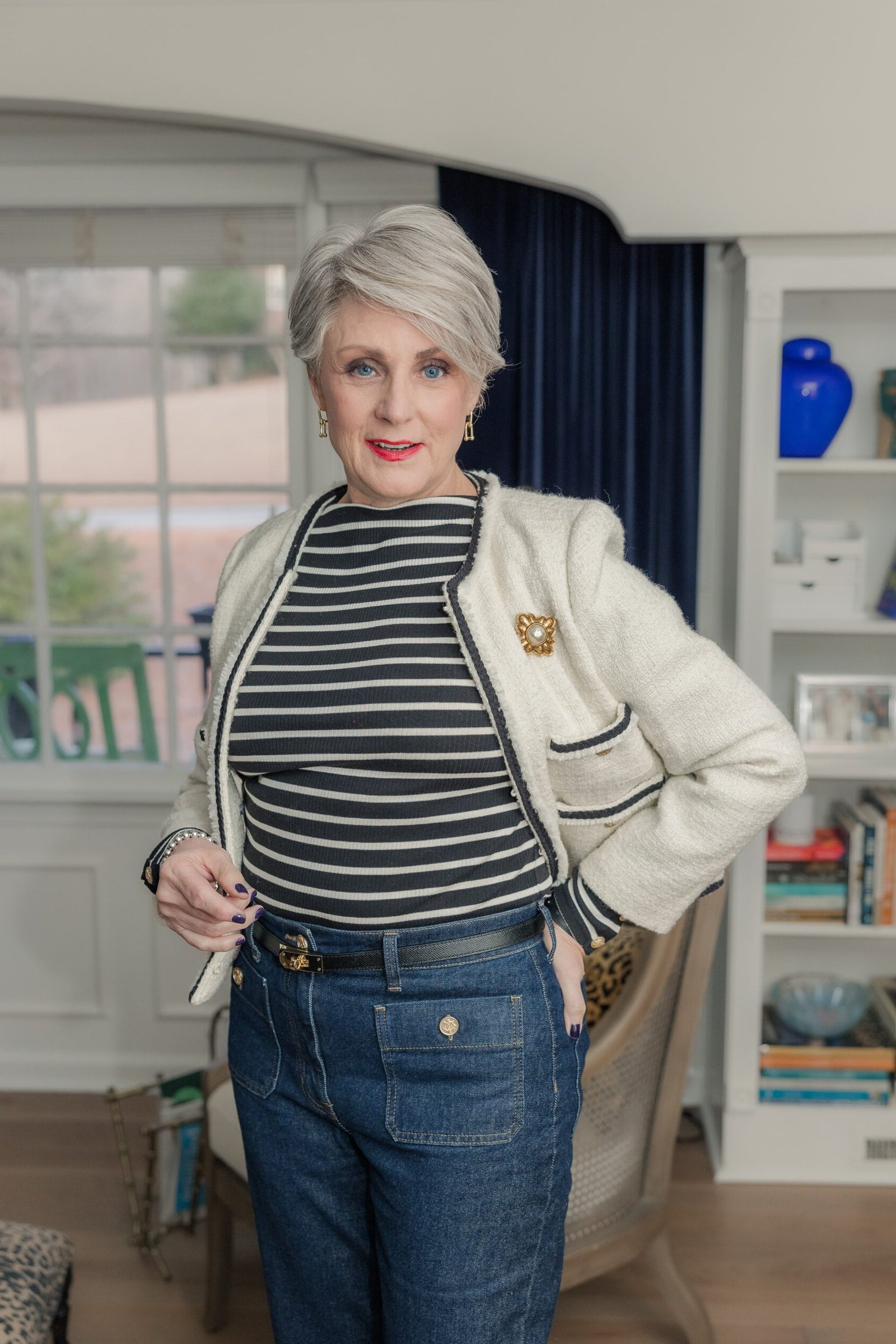 Striped top, cream cardigan, dark jeans, living room - denim outfit idea for women over 50