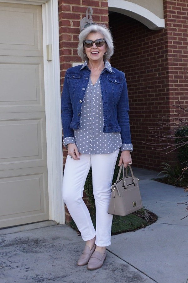 Denim jacket, polka-dot top, white jeans, gray handbag - denim outfit idea for women over 50