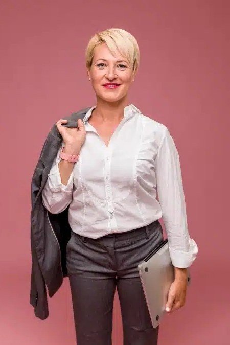 white shirt, gray trousers, pink studio backdrop