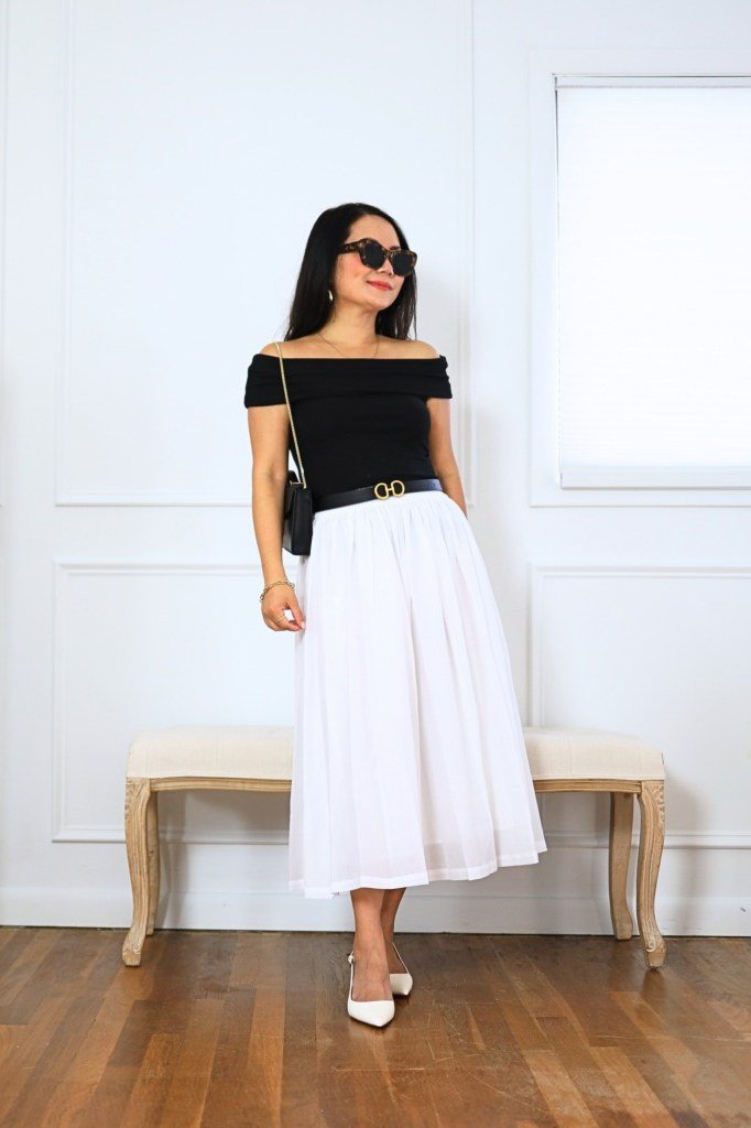 black off-shoulder top, white midi skirt, white heels
