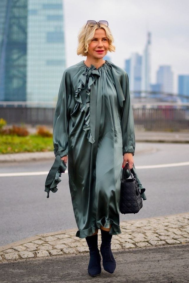 green satin midi dress, black boots, city street