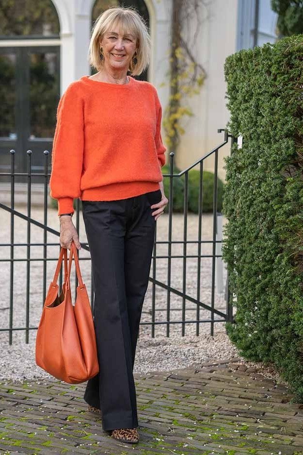 orange knit sweater, black wide-leg pants, orange tote