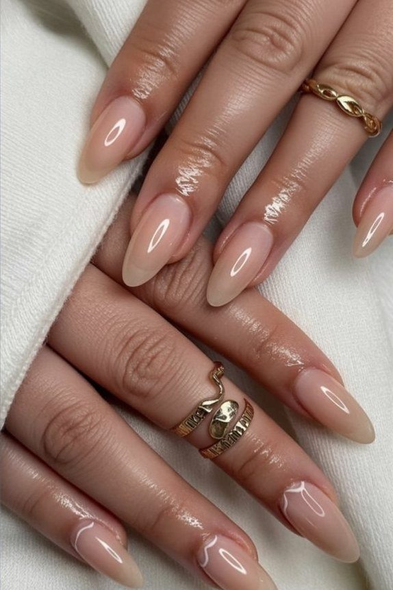 Glossy Nude Almond Nails with Gold Rings - elegant almond nail idea for women over 60