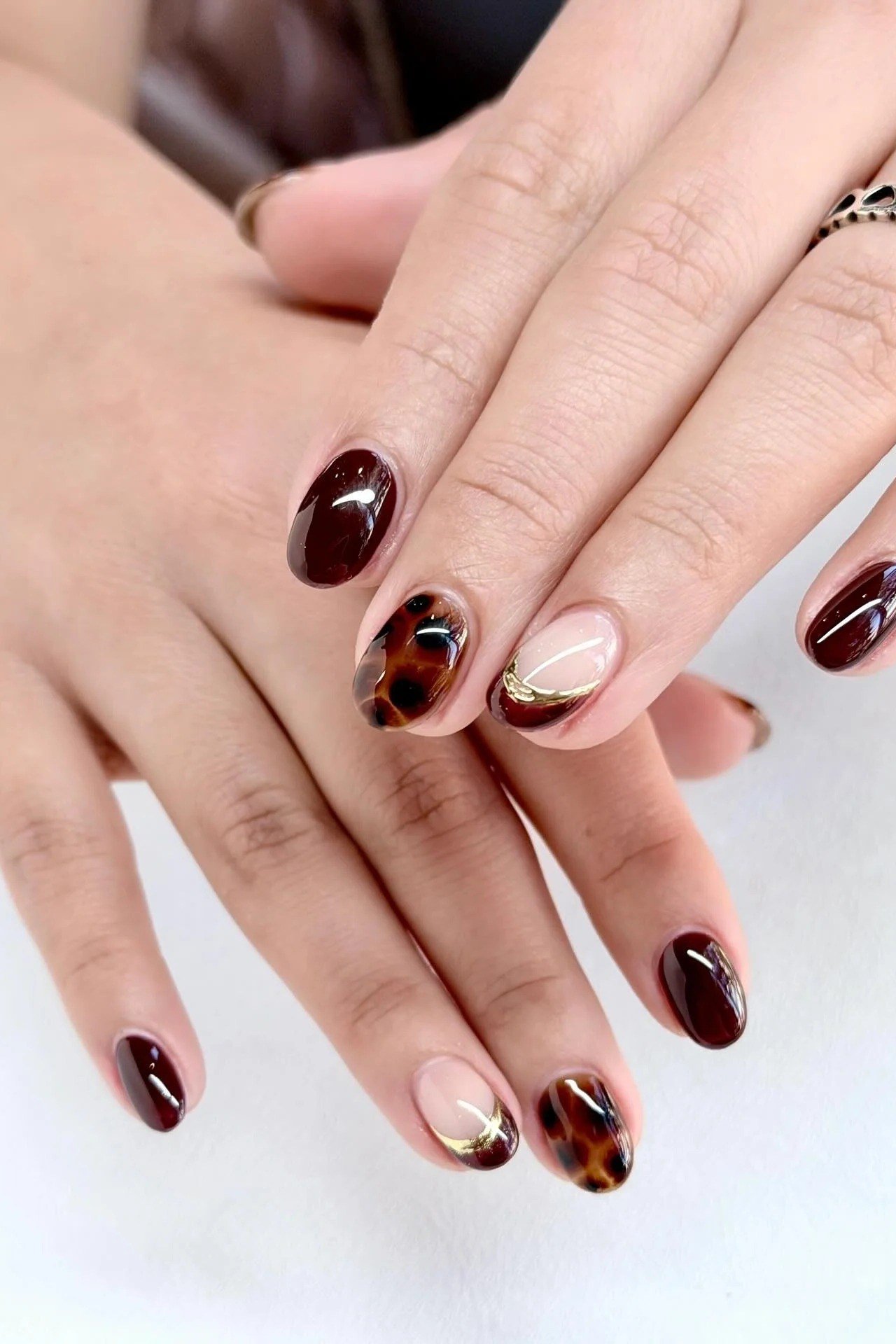 Burgundy Almond Nails with Tortoiseshell Accent - elegant almond nail idea for women over 60