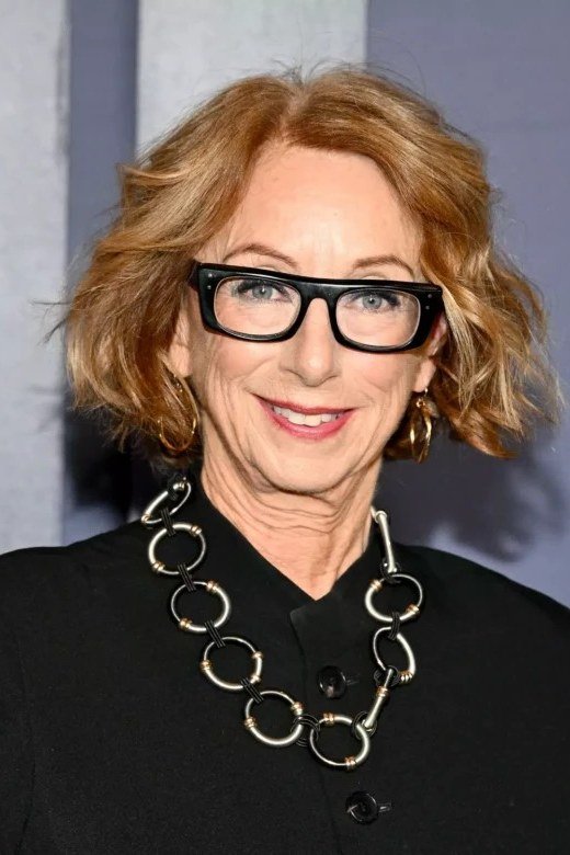 Copper curly layered bob with glasses for women over 50
