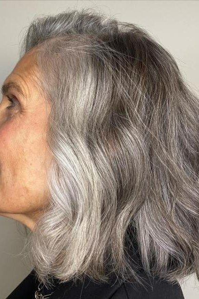Long wavy grey layered bob for women over 50
