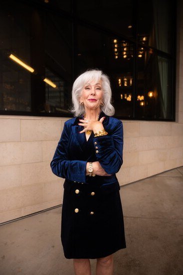 Navy velvet blazer with black skirt for older women