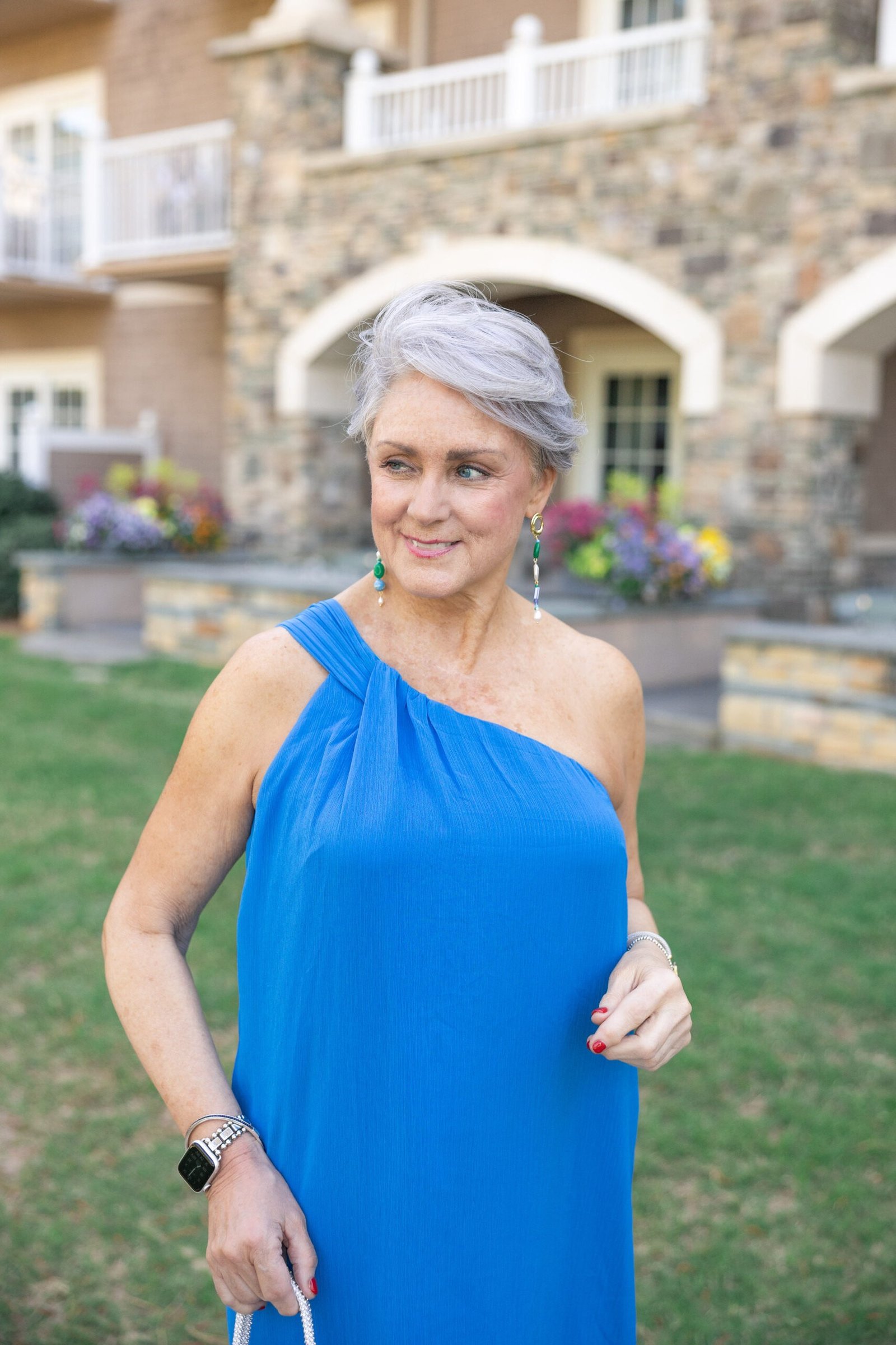 Cobalt blue one-shoulder dress in a garden for older women