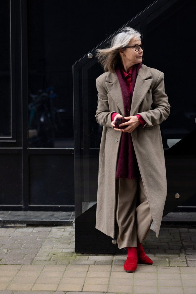 Beige trench with burgundy scarf and red shoes for older women
