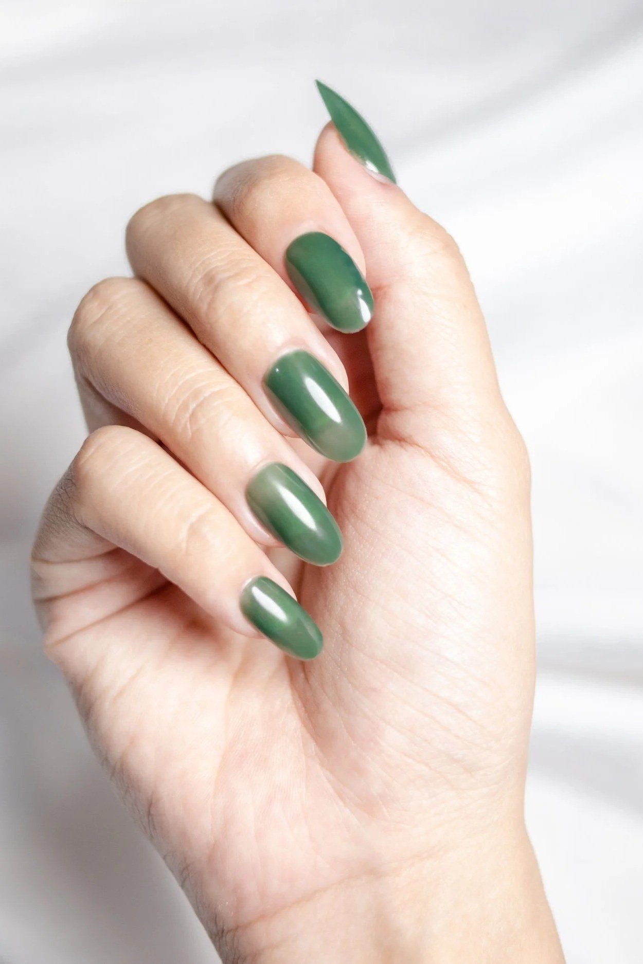 Sage Almond Nails on a White Top - emerald green nail design for women over 50