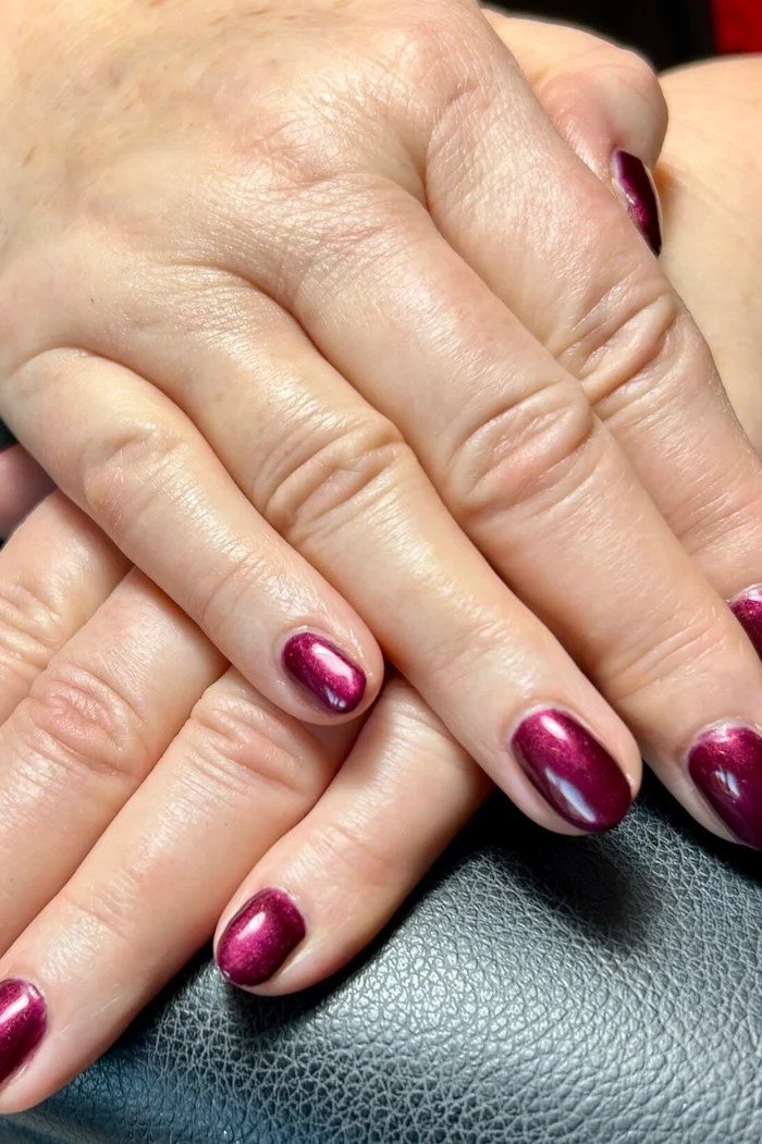 Magenta-red chrome shimmer nails, elegant nail idea for women over 50