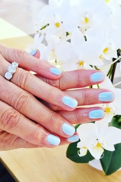 Sky blue glossy nails, elegant nail idea for women over 50