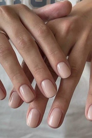 Warm tan-nude glossy nails, elegant nail idea for women over 50