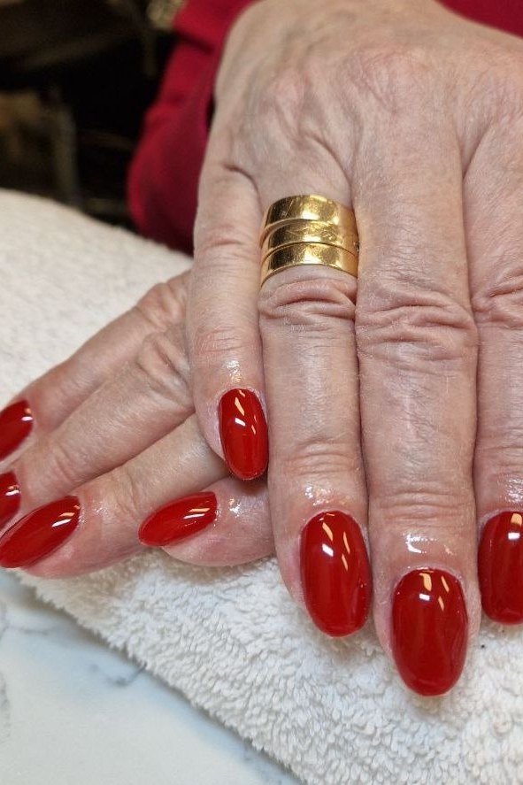 Red with Gold Rings on a White Towel, elegant nail idea for women over 60