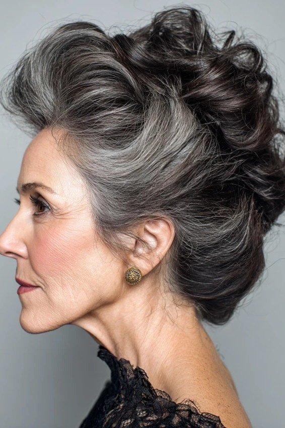 Dark grey voluminous updo in profile, an elegant updo for women over 70