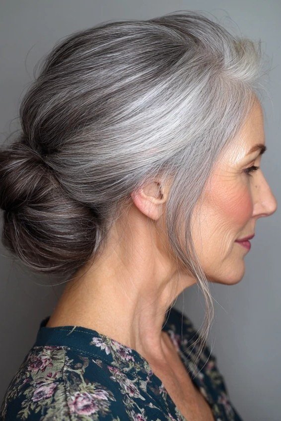 Grey side bun in profile in floral dress, an elegant updo for women over 70