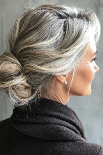 Messy silver bun side view with dark scarf, an elegant updo for women over 70