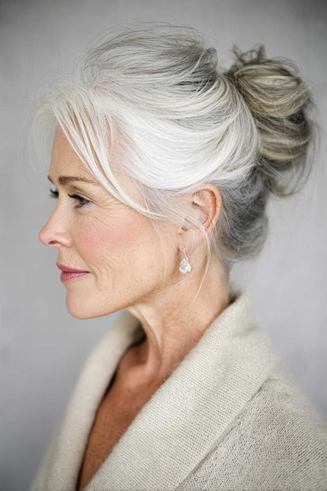 White top bun in profile with cream shawl, an elegant updo for women over 70