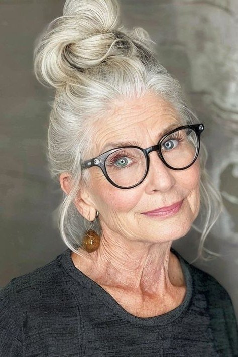 White top knot front view with glasses, an elegant updo for women over 70