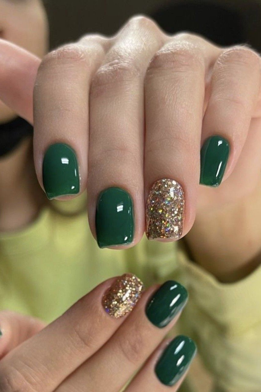 Short dark green nails with gold glitter accents for women over 60