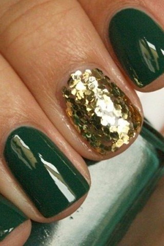 Chunky gold glitter and dark green nails close-up manicure