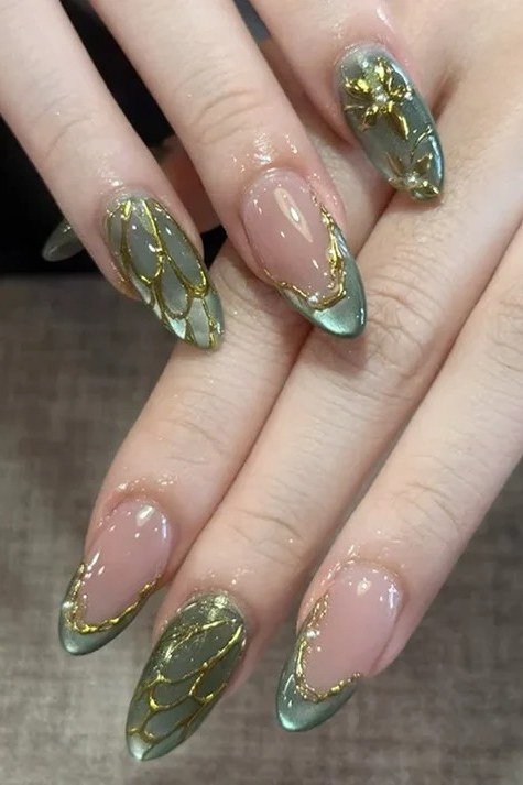 Nude nails with green and gold botanical nail art for women over 60
