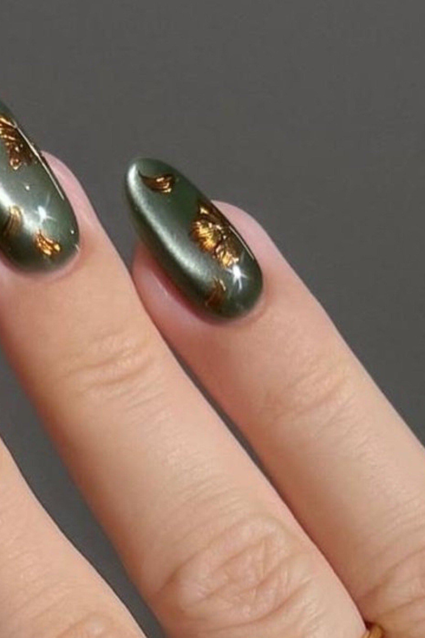 Metallic olive green nails with gold sheen for women over 60