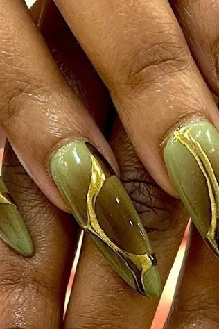 Green nails with gold swirl nail art for women over 60
