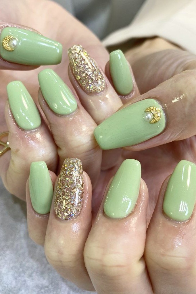 Light green nails with gold glitter accents for women over 60
