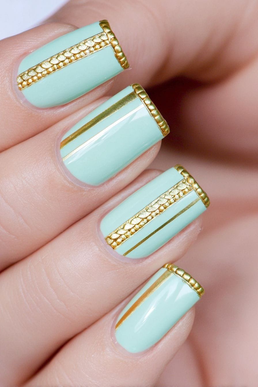 Mint green nails with gold band details for women over 60