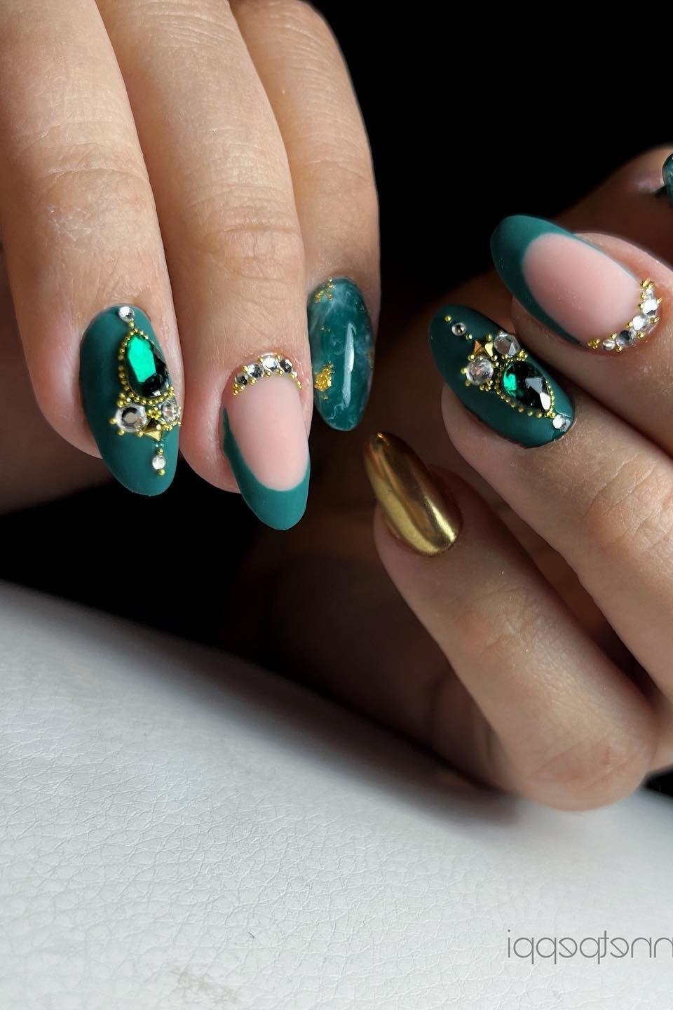 Teal green nails with gold gem accents for women over 60
