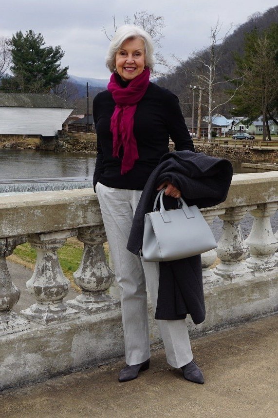 Black Coat with Magenta Scarf on a Bridge, elegant winter outfit for women over 60