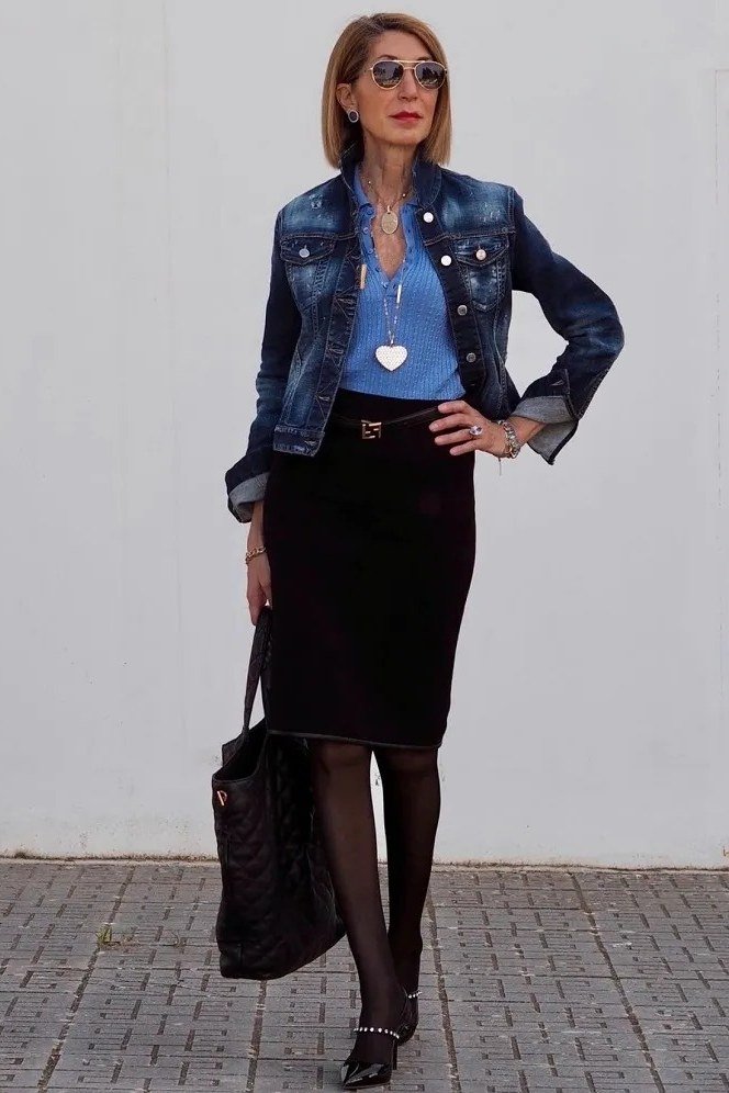 Elegant work outfit for women over 50: denim jacket, blue top, black skirt, tights, black tote, street style