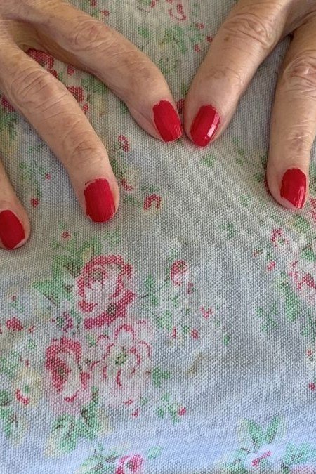 Classic Red on a Floral Tablecloth, elegant winter nail color idea for older women