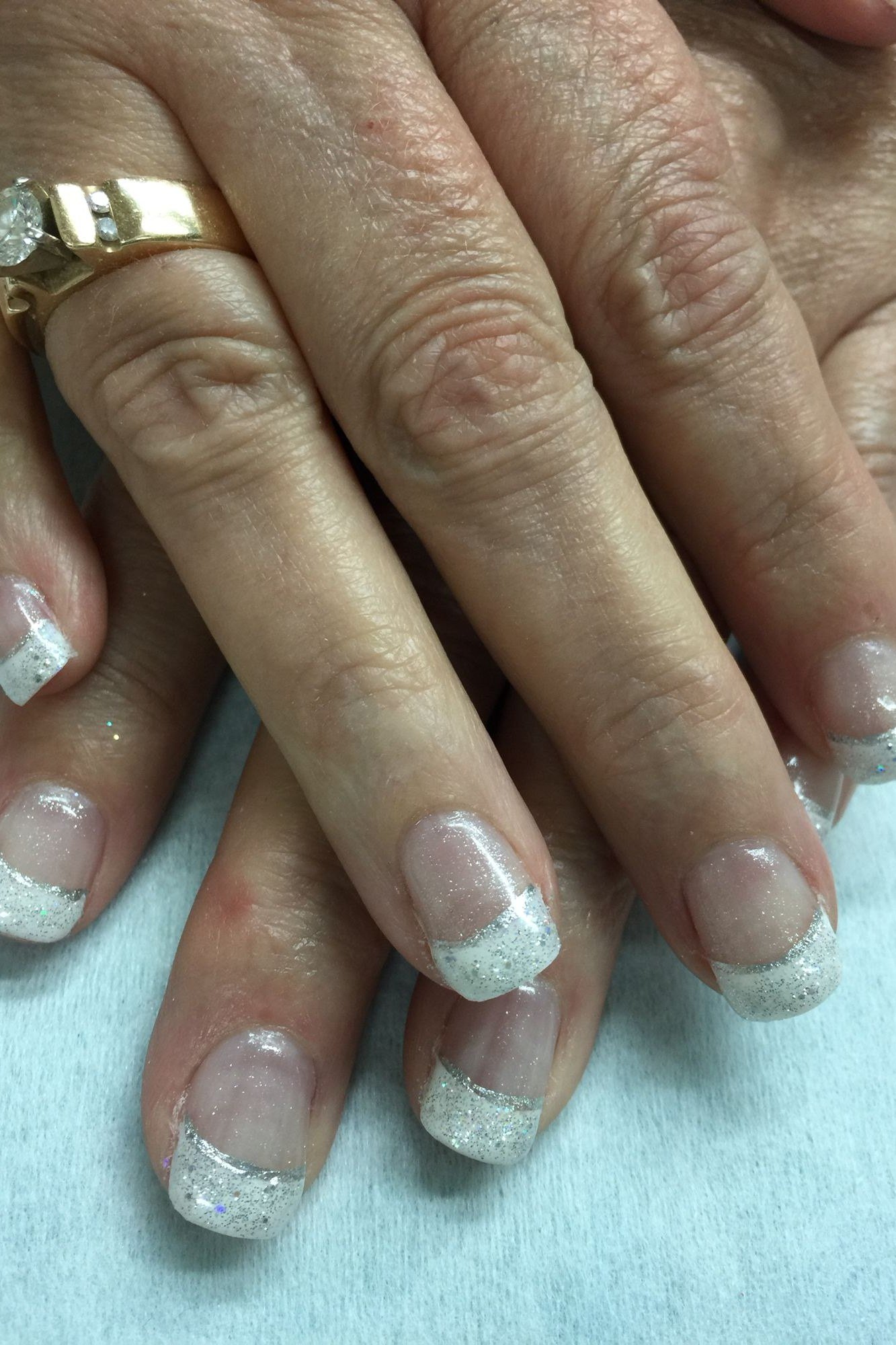 Sheer Glitter French on Mature Hands - elegant wedding nails for women over 60