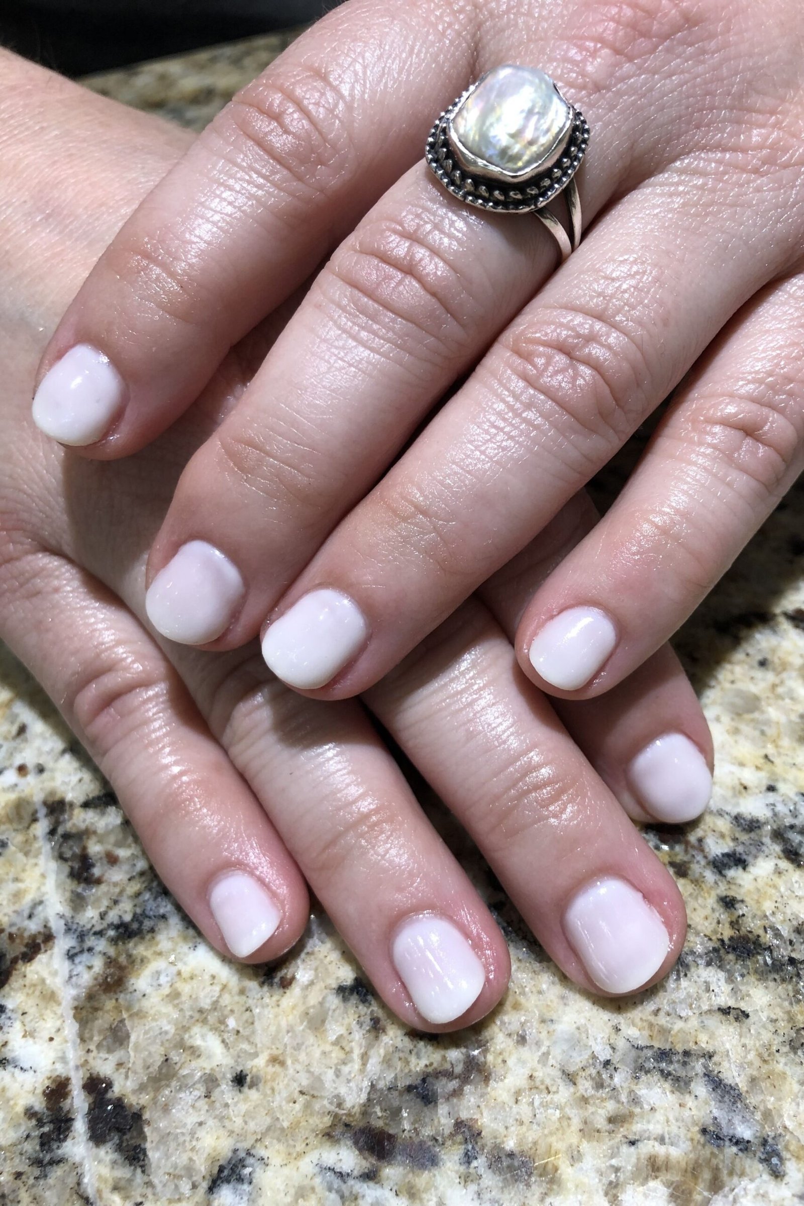 Milky White Short Square Nails - milky white short square nails, older hands with statement ring - elegant nail idea for women over 40