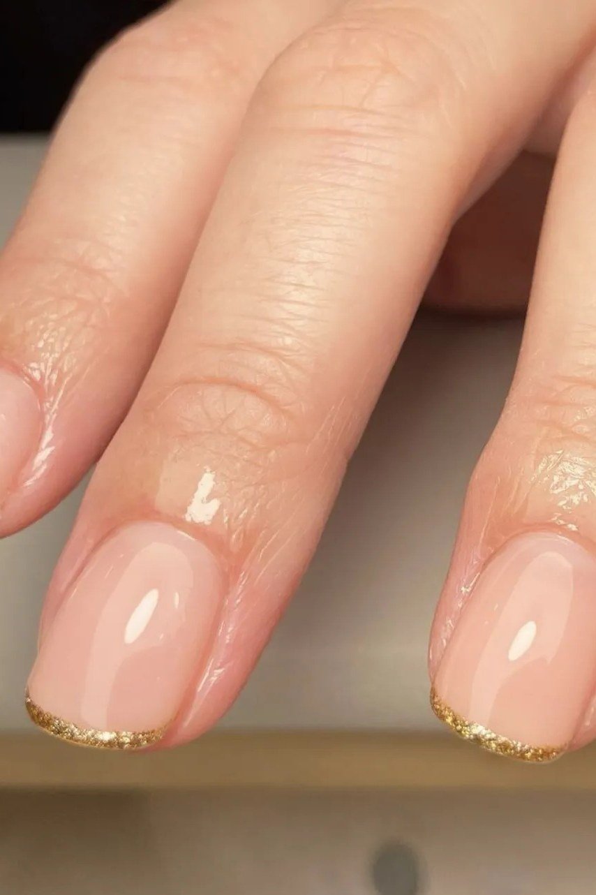 Nude Pink Nails with Gold Glitter Tips - elegant short nail idea for women over 50