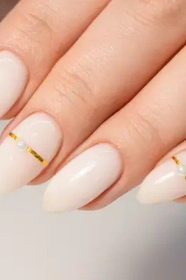 Cream White Nails with Gold Lines - elegant short nail idea for women over 50