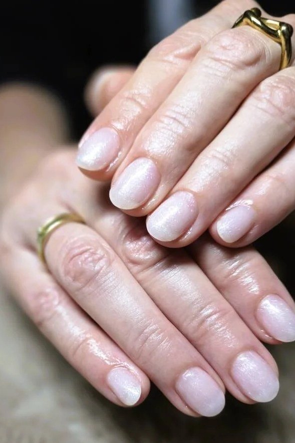 Sheer Pink Nails with Gold Rings - elegant short nail idea for women over 50