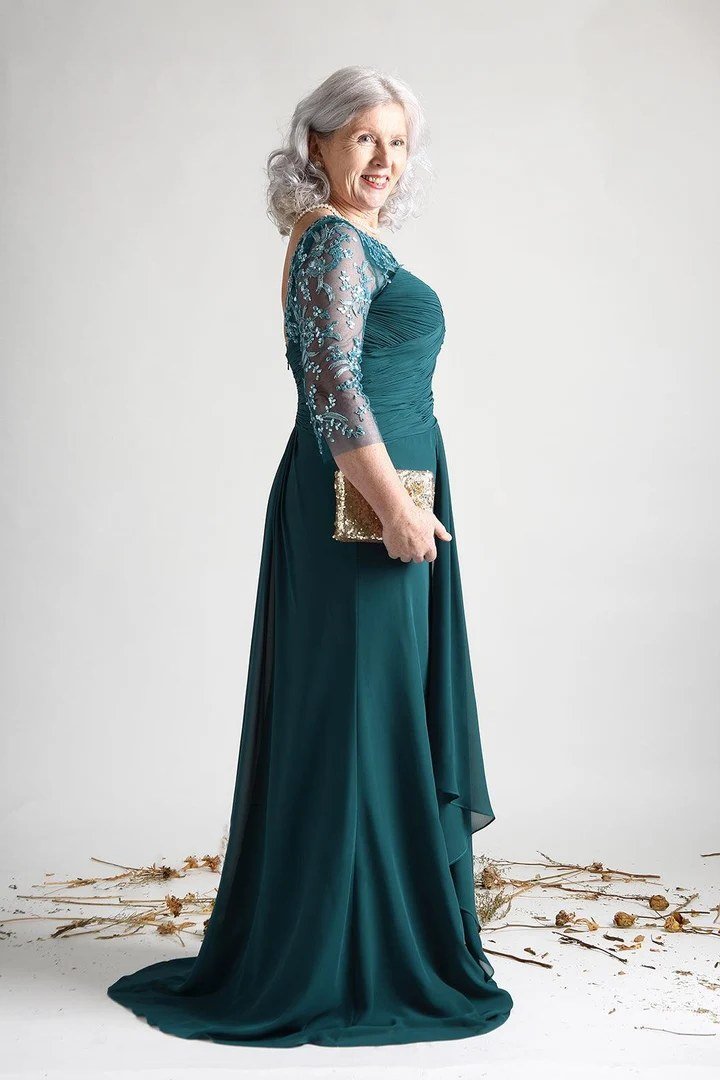 Teal lace evening gown with three-quarter sleeves on an older woman