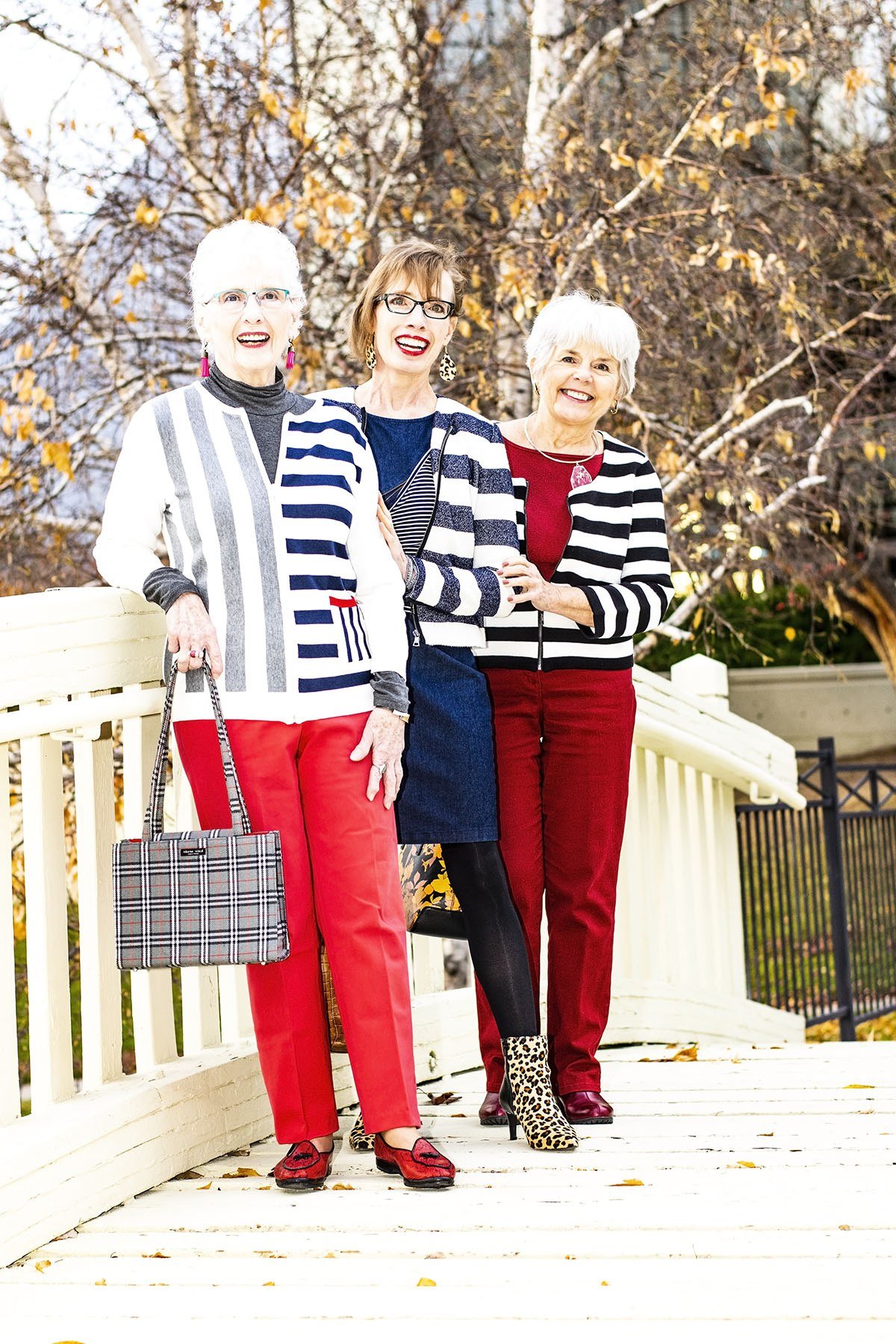 three older women in striped tops with red, navy and white bottoms - fall outfit idea for women over 70