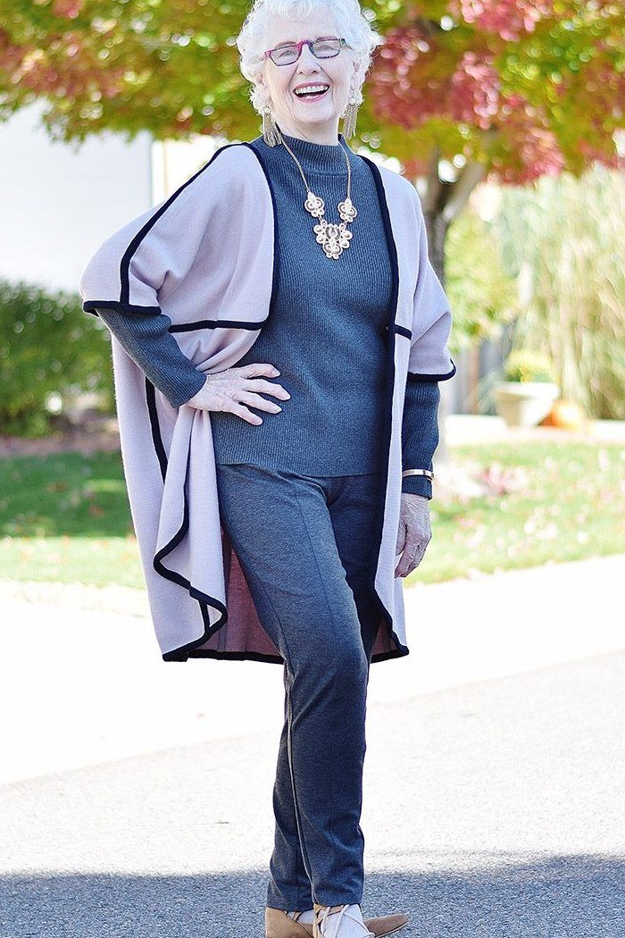 navy turtleneck with long gray vest and dark jeans, statement necklace - fall outfit idea for women over 70