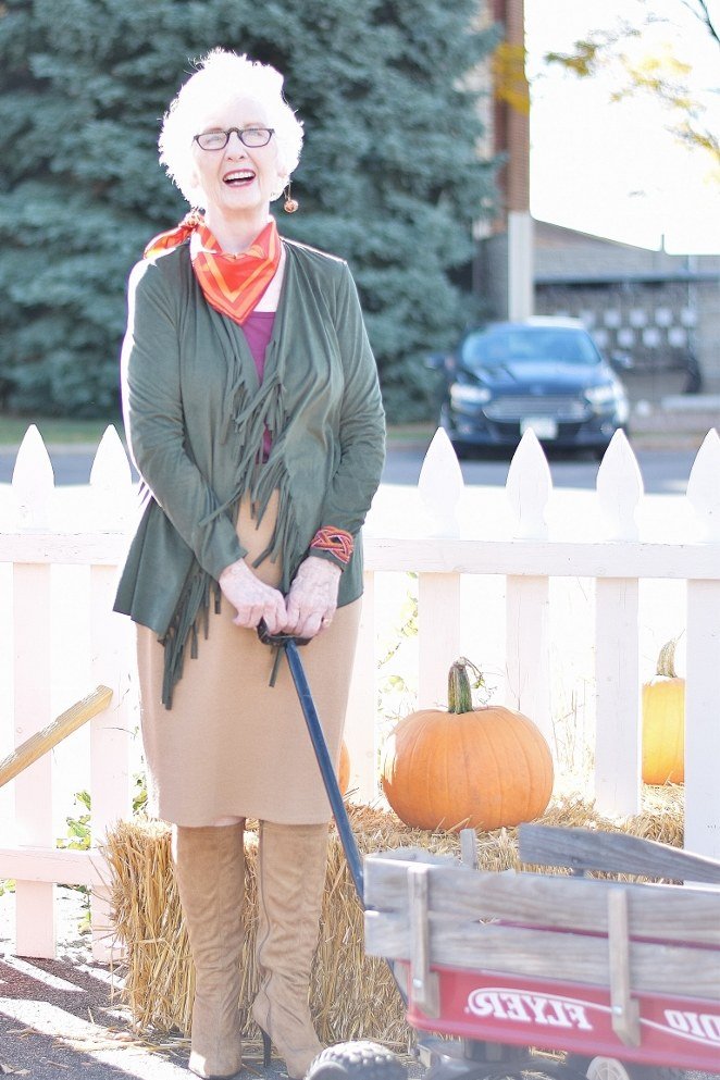 olive cardigan with rust scarf, tan skirt and tan boots by pumpkin wagon - fall outfit idea for women over 70