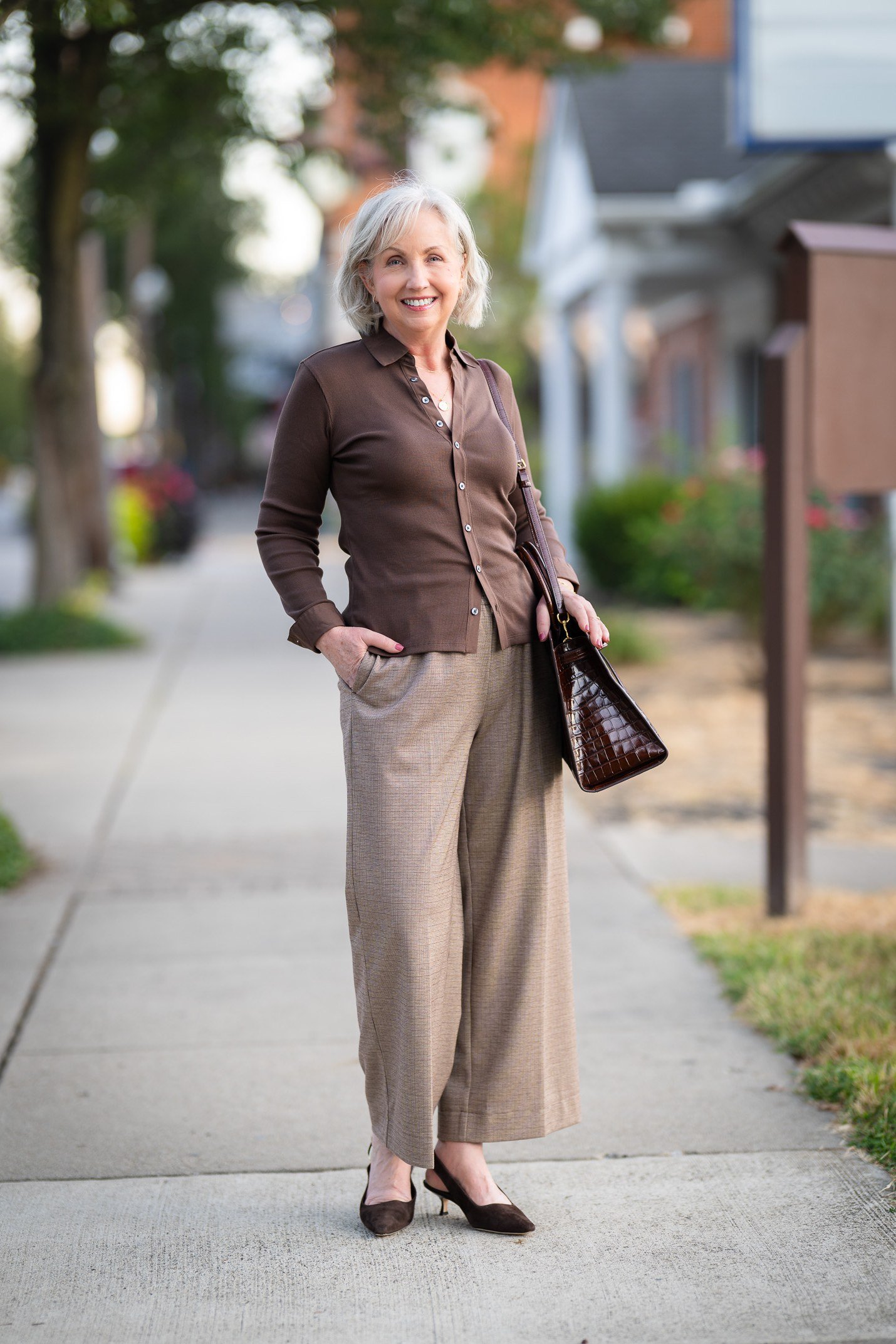 brown cardigan with tan wide-leg pants, older woman on sidewalk - fall outfit idea for women over 70