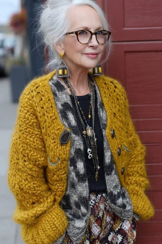 Mustard chunky knit cardigan over patterned top, 3/4 front view - fall cardigan outfit idea for women over 60