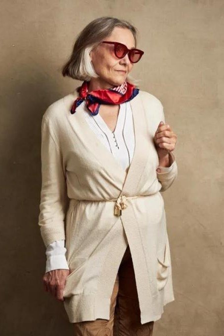Cream belted long cardigan with red scarf and sunglasses, 3/4 view, elegant - fall cardigan outfit idea for women over 60