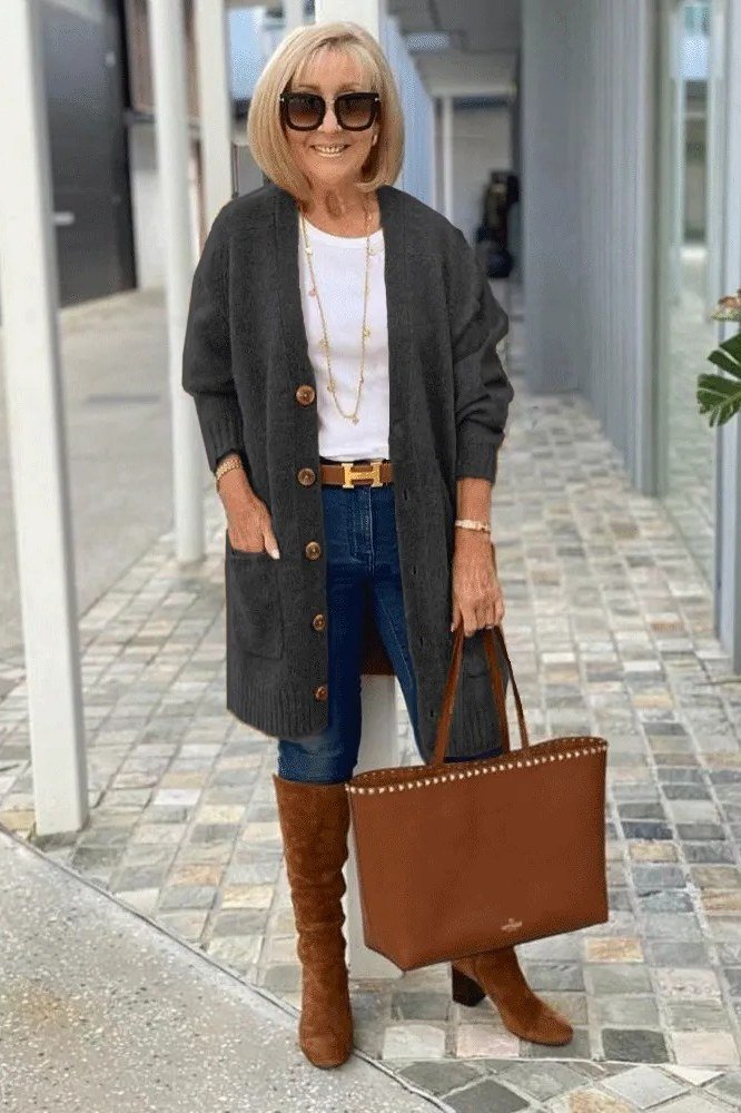 Charcoal long open cardigan over white tee, blue jeans, tan knee boots and tote, full body front view, street - fall cardigan outfit idea for women over 60