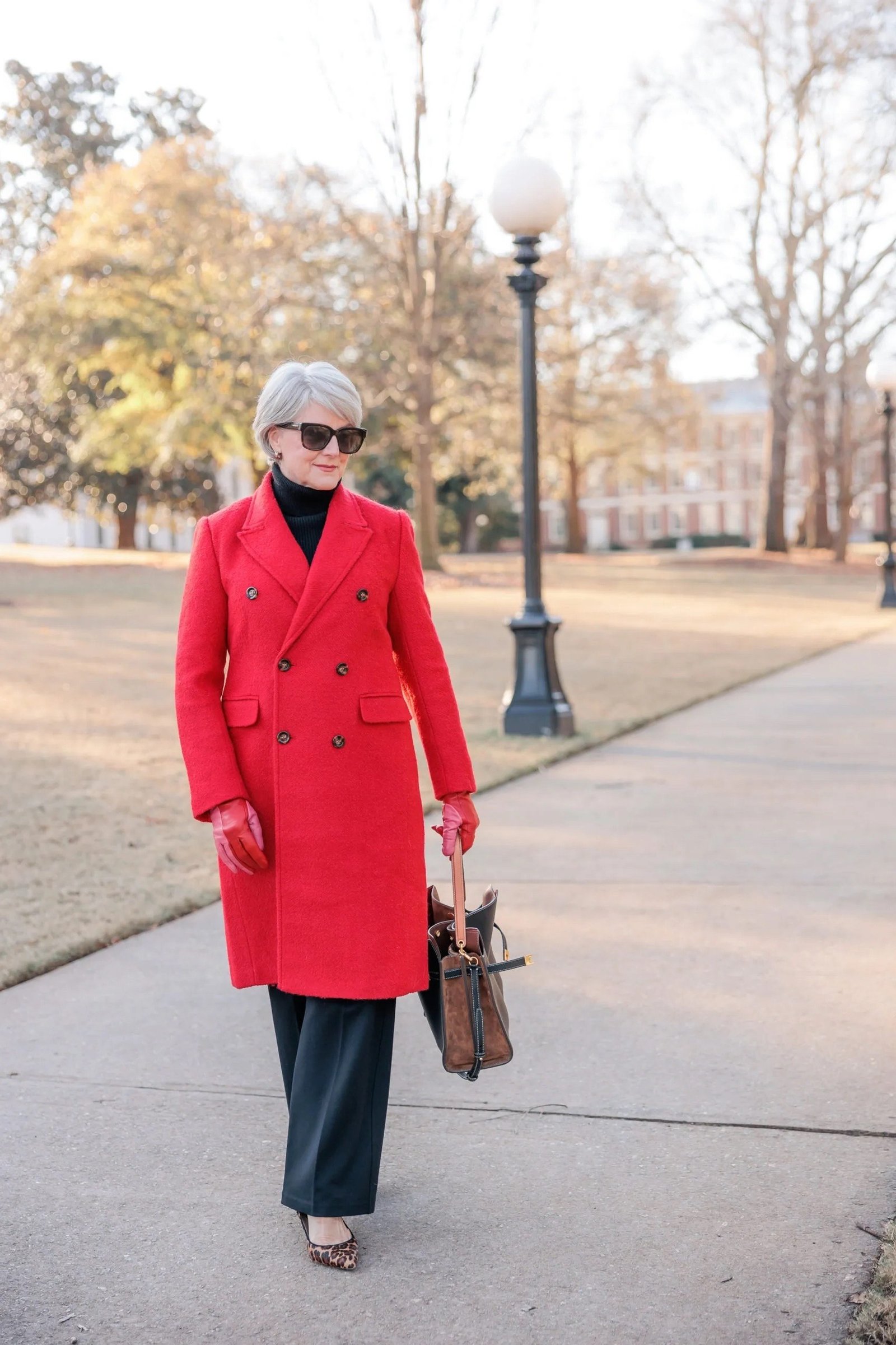 Older woman wearing a red coat with dark trousers for fall