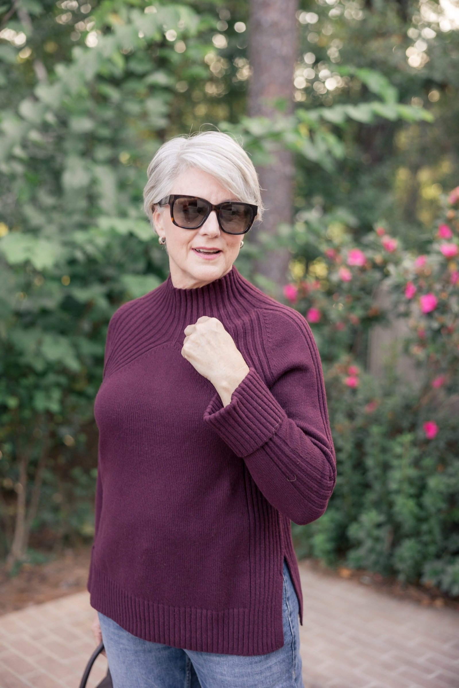 Older woman in a plum turtleneck sweater