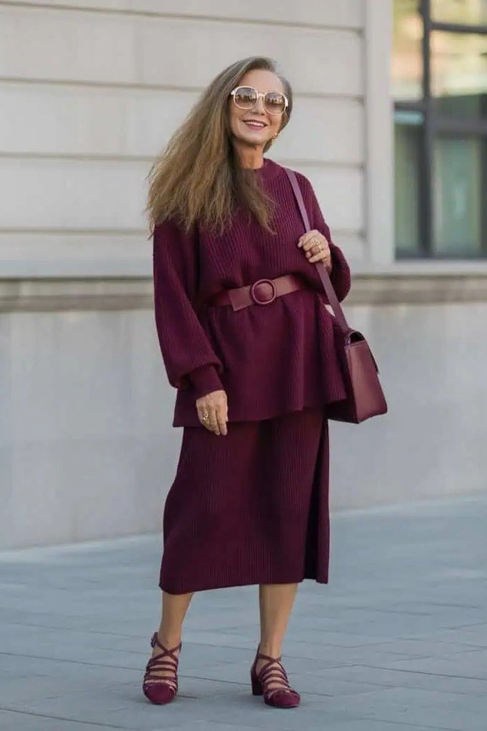 Older woman in a burgundy knit sweater set